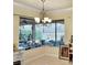 Charming dining area illuminated by a chandelier, with large windows offering scenic backyard views at 15207 17Th E Ave, Bradenton, FL 34212