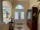 Inviting foyer with double doors, tile flooring, arched doorway, and decorative glass accents at 15207 17Th E Ave, Bradenton, FL 34212