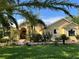 Charming home featuring lush landscaping, manicured lawn, and a welcoming front entrance with a brick walkway at 15207 17Th E Ave, Bradenton, FL 34212