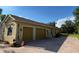 Side view of a home with a three car garage and paved driveway at 15207 17Th E Ave, Bradenton, FL 34212