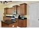 Well-equipped kitchen boasting black granite countertops, stainless steel appliances, wood cabinets, and an island at 15207 17Th E Ave, Bradenton, FL 34212