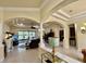 Open living area with decorative columns, tray ceilings, and sliding glass doors to the lanai at 15207 17Th E Ave, Bradenton, FL 34212
