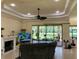 Cozy living room boasts a fireplace, tray ceiling, and sliding glass doors to the outdoor patio at 15207 17Th E Ave, Bradenton, FL 34212
