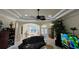 Bright living room featuring a ceiling fan, arched doorways, and neutral color palette at 15207 17Th E Ave, Bradenton, FL 34212