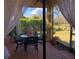 Enclosed patio with garden view features dining area and brick flooring for outdoor enjoyment and relaxation at 15207 17Th E Ave, Bradenton, FL 34212