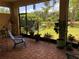 Screened patio with tranquil garden views, a chair, and outdoor seating, for relaxation and enjoyment at 15207 17Th E Ave, Bradenton, FL 34212