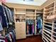 Large walk-in closet featuring custom shelving, drawers, and hanging space for organized clothing storage at 15207 17Th E Ave, Bradenton, FL 34212