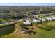A stunning high aerial view of a golf community with mature trees and green landscaping at 276 Cerromar Way # 60, Venice, FL 34293
