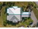 A bird's-eye view of a single-story home showcasing its roof, landscaping, and adjacent carport at 276 Cerromar Way # 60, Venice, FL 34293