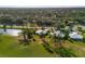 High aerial view of a community with golf course and ponds and homes with mature trees and landscaping at 276 Cerromar Way # 60, Venice, FL 34293