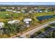 Expansive aerial shot of home in a lush golf community, showcasing the neighborhood and landscaping at 276 Cerromar Way # 60, Venice, FL 34293