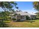 The well-maintained backyard shows a house with screened-in porch and beautifully landscaped yard at 276 Cerromar Way # 60, Venice, FL 34293