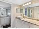 Elegant bathroom featuring double sinks, marble countertops, and modern fixtures at 276 Cerromar Way # 60, Venice, FL 34293