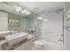 Bright bathroom featuring a tub with glass doors, stylish vanity with vessel sink and decorative lighting at 276 Cerromar Way # 60, Venice, FL 34293