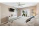 Bedroom featuring a cozy bed, TV, and view of the outdoors from sliding glass doors at 276 Cerromar Way # 60, Venice, FL 34293