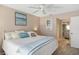 Inviting bedroom with a comfortable bed, ceiling fan, and access to the bathroom at 276 Cerromar Way # 60, Venice, FL 34293