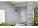 Welcoming entryway with a storm door and stylish outdoor lighting fixture, perfect for guests at 276 Cerromar Way # 60, Venice, FL 34293