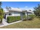 Charming single-story home with a tidy front yard and manicured hedges creating a welcoming entrance at 276 Cerromar Way # 60, Venice, FL 34293