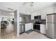 Bright, updated kitchen with stainless appliances and a view into the living room at 276 Cerromar Way # 60, Venice, FL 34293