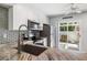 Well-equipped kitchen with stainless steel appliances, sleek cabinetry, and a view of the outdoor patio at 276 Cerromar Way # 60, Venice, FL 34293