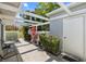 A covered patio has seating and plantings, offering a serene outdoor retreat adjacent to the house at 276 Cerromar Way # 60, Venice, FL 34293