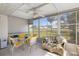 Screened in porch with outdoor furniture offers beautiful views of the manicured lawn and mature landscaping at 276 Cerromar Way # 60, Venice, FL 34293