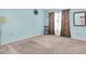 This bedroom features neutral carpet, a window with curtains, and a statement floral wall decoration at 3403 36Th W St # 109, Bradenton, FL 34205