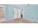 This bedroom features neutral carpet, two white doors, and pale-blue painted walls at 3403 36Th W St # 109, Bradenton, FL 34205