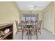 Bright dining area features tile flooring, seating for four, and sliding doors to lanai at 3403 36Th W St # 109, Bradenton, FL 34205