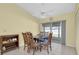 Bright dining area features tile flooring, seating for four, and sliding doors to lanai at 3403 36Th W St # 109, Bradenton, FL 34205