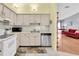 Bright kitchen featuring white appliances, modern dishwasher, and wood floors at 3403 36Th W St # 109, Bradenton, FL 34205