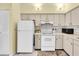 Well-lit kitchen featuring white appliances and ample storage space at 3403 36Th W St # 109, Bradenton, FL 34205