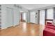 Cozy living room featuring wood floors, ample storage, and a bright front door at 3403 36Th W St # 109, Bradenton, FL 34205