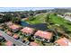 Stunning aerial view of property showcasing the lush landscaping, lake, and the golf course at 3500 El Conquistador Pkwy # 336, Bradenton, FL 34210