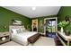 Comfortable bedroom featuring a king bed, an ensuite and an access to the patio at 3500 El Conquistador Pkwy # 336, Bradenton, FL 34210