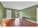 Large bedroom with laminated floors, a patio entrance, and neutral-colored walls at 3500 El Conquistador Pkwy # 336, Bradenton, FL 34210