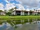 Exterior water view of a community with palm trees and scenic water reflection at 3500 El Conquistador Pkwy # 336, Bradenton, FL 34210