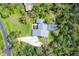 Bird's eye view of property with a screened pool and wooded backyard at 3651 Walden Pond Dr, Sarasota, FL 34240