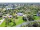 Aerial view of the property showing the home, surrounding trees, and nearby pond at 3651 Walden Pond Dr, Sarasota, FL 34240