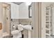Bathroom featuring a stylish pedestal sink, toilet, glass-enclosed shower, and elegant finishes at 3651 Walden Pond Dr, Sarasota, FL 34240