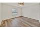 Bedroom with hardwood floors, large windows, and a ceiling fan at 3651 Walden Pond Dr, Sarasota, FL 34240