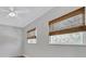 Bedroom featuring two windows with textured shades and a ceiling fan with lighting at 3651 Walden Pond Dr, Sarasota, FL 34240