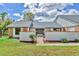 Charming single-story home featuring a manicured lawn, brick accents, and a welcoming double-door entrance at 3651 Walden Pond Dr, Sarasota, FL 34240