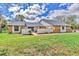 Inviting single-story home with lush green lawn and brick accents on a sunny day at 3651 Walden Pond Dr, Sarasota, FL 34240