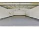 An attached garage with freshly painted walls and floor is ready for your vehicles and storage at 3651 Walden Pond Dr, Sarasota, FL 34240