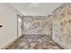 Inviting hallway with painted brick walls, tile flooring, and a doorway leading to the outdoors at 3651 Walden Pond Dr, Sarasota, FL 34240