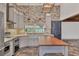 Contemporary kitchen featuring stainless appliances, large island, and custom cabinetry at 3651 Walden Pond Dr, Sarasota, FL 34240