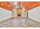 Open living area features a brick fireplace, wood ceiling, and tiled floors at 3651 Walden Pond Dr, Sarasota, FL 34240