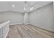 Open loft space with a closet, fan and white railing overlooking the stairway entrance at 3651 Walden Pond Dr, Sarasota, FL 34240