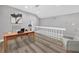 Gray office space with vaulted ceiling featuring white railings and wood floors at 3651 Walden Pond Dr, Sarasota, FL 34240